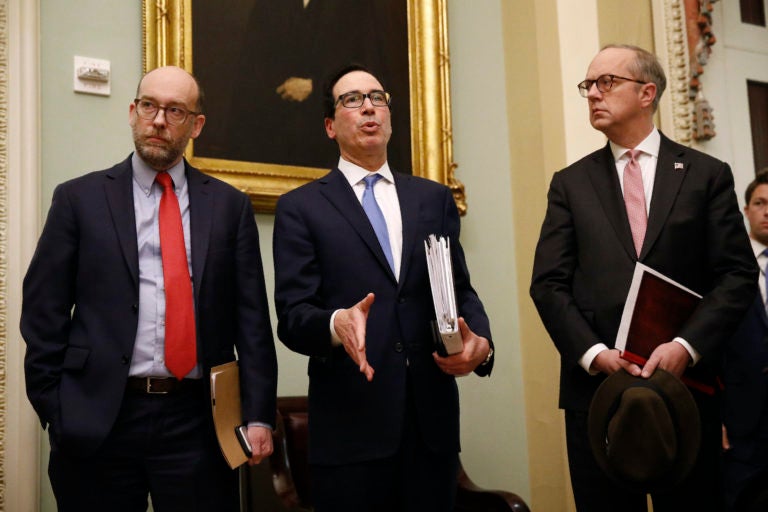 Treasury Secretary Steve Mnuchin, center, speaks with members of the media as he departs a meeting with Senate Republicans on an economic lifeline for Americans affected by the coronavirus outbreak. on Capitol Hill in Washington, Monday, March 16, 2020. (Patrick Semansky/AP Photo)