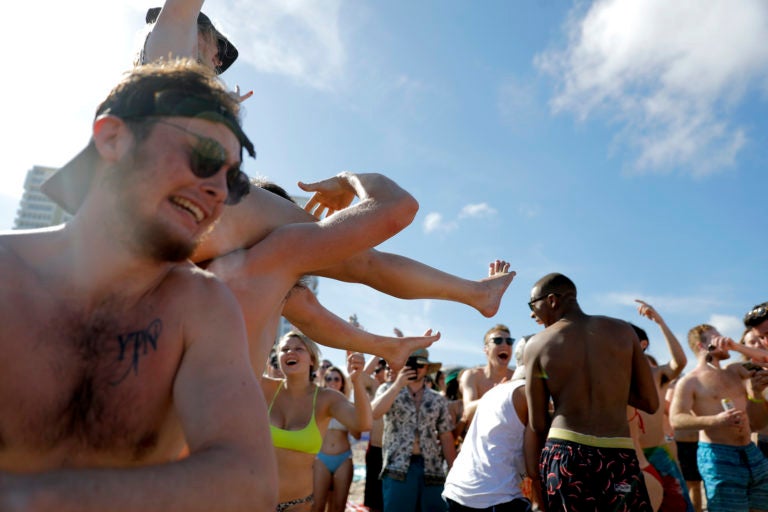 Spring break revelers party on the beach, Tuesday, March 17, 2020, in Pompano Beach, Fla. (Julio Cortez/AP Photo)