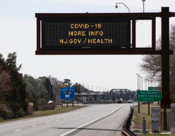 A notice is displayed above the lightly traveled Garden State Parkway in Ocean View, N.J., Wednesday, March 18, 2020. (AP Photo/Matt Rourke)
