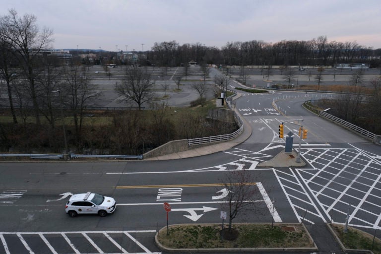 A security car cruises the almost completely empty parking lots of Garden State Plaza in Paramus, N.J., Wednesday, March 18, 2020. (Seth Wenig/AP Photo)