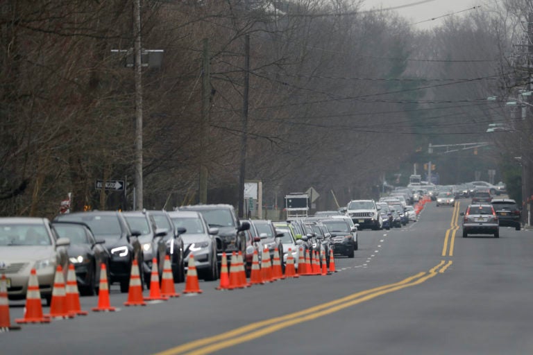 A long line of cars waits to enter a drive-through COVID-19 coronavirus testing center in Paramus, N.J., Friday, March 20, 2020. (Seth Wenig/AP Photo)