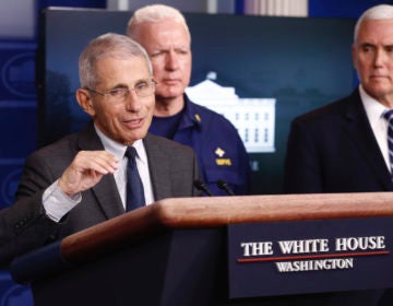 Director of the National Institute of Allergy and Infectious Diseases Dr. Anthony Fauci speaks during a coronavirus task force briefing at the White House, Saturday, March 21, 2020, in Washington. Adm. Brett Giroir, assistant secretary for health, center, and Vice President Mike Pence listen. (AP Photo/Patrick Semansky)