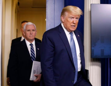 President Donald Trump and Vice President Mike Pence arrive to speak at a coronavirus task force briefing at the White House, Saturday, March 21, 2020, in Washington. (AP Photo/Patrick Semansky)