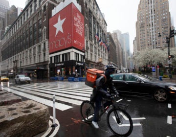 A cyclist passes Macy's in Herald Square, Monday, March 23, 2020, in New York. Macy's stores nationwide are closed due to the coronavirus. (Mark Lennihan/AP Photo)