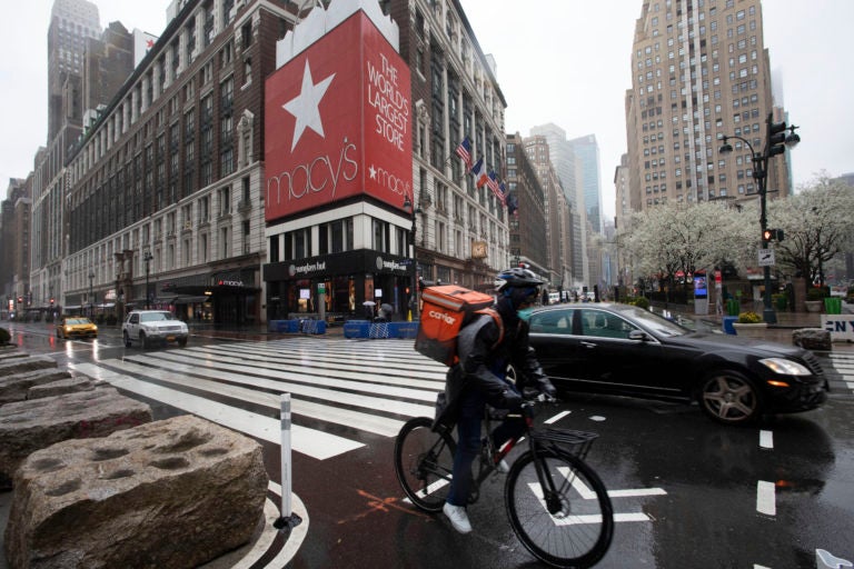 A cyclist passes Macy's in Herald Square, Monday, March 23, 2020, in New York. Macy's stores nationwide are closed due to the coronavirus. (Mark Lennihan/AP Photo)