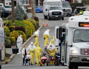 Residents from St. Joseph's Senior Home are helped on to buses in Woodbridge, N.J., Wednesday, March 25, 2020. (Seth Wenig/AP Photo)