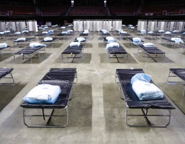 A federal medical station is set up at Temple University's Liacouras Center in Philadelphia, Monday, March 30, 2020, to accommodate an influx in hospital patients due to the coronavirus outbreak. (AP Photo/Matt Rourke)