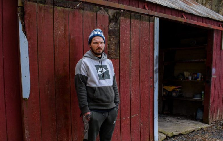 Jordan Bugg stands outside a shed at his mothers home, where he lives, in Catawissa, Pennsylvania. Jordan suffered from a tooth abscess in the Lebanon County jail, which he says was ignored by medical staff until he ended up on life support. (Joseph Darius Jaafari/PA Post)