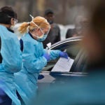 A nurse with ChristianaCare gives a free test for the coronavirus to a driver in Delaware. (Butch Comegys for WHYY)