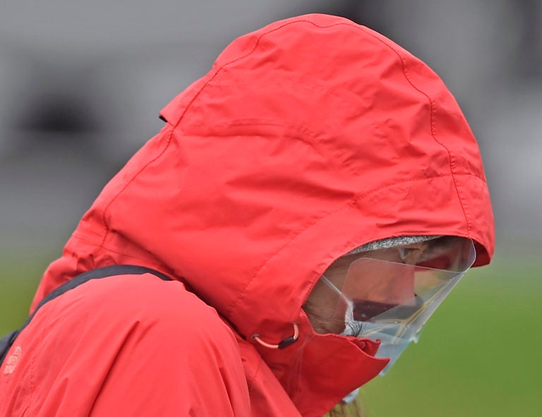 A woman walks across Beech Street after being tested for the coronavirus at the Riverfront complex in downtown Wilmington, Delaware on Friday, March 13, 2020. Christiana Care, Delaware's largest health system, provided the free tests. (Butch Comegys / For WHYY)