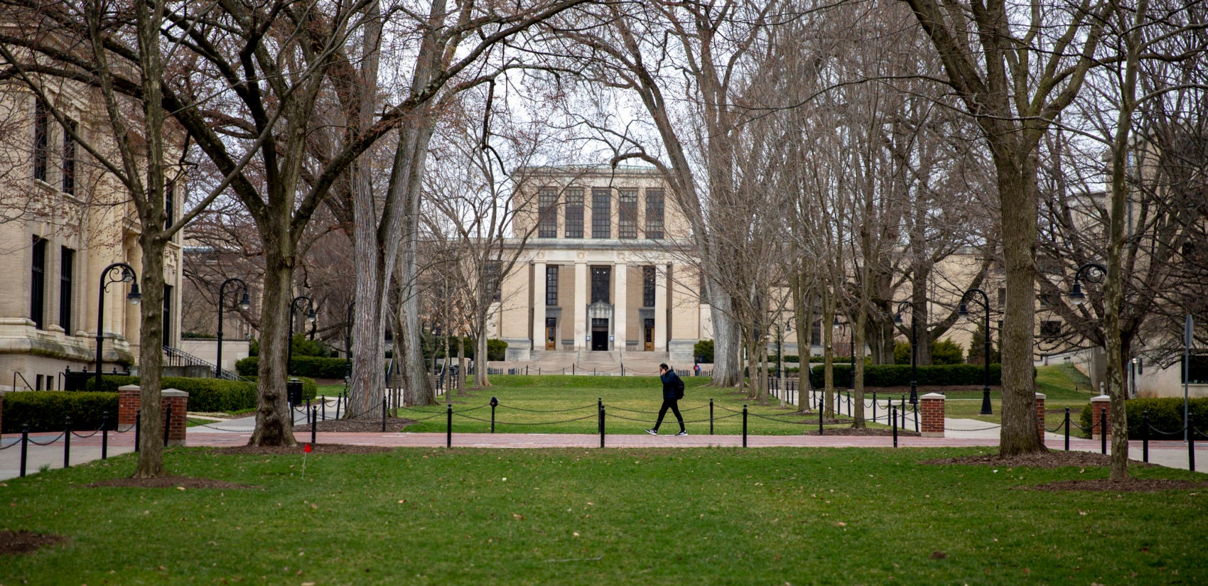 A student walks alone at Penn State’s University Park campus, where coronavirus has suspended in-person classes. (Min Xian / WPSU)