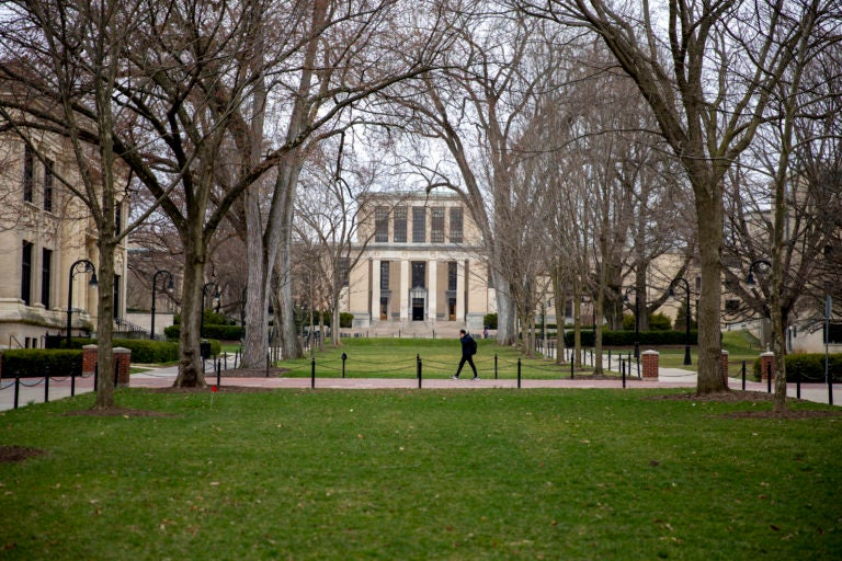 A student walks alone at Penn State’s University Park campus, where coronavirus has suspended in-person classes. (Min Xian / WPSU)