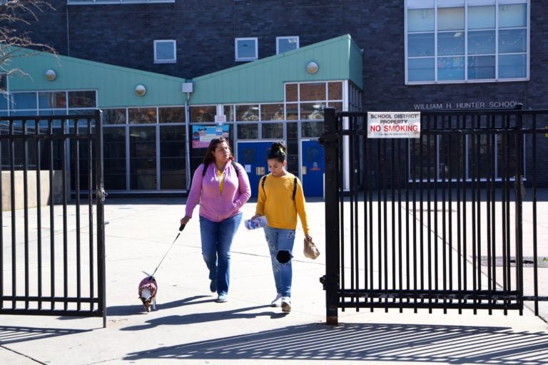 Xiomara Diaz and her daughter Genesis Diaz leave William Hunter School in Kensington with free meals because of the coronavirus shutdown. (Kimberly Paynter/WHYY)