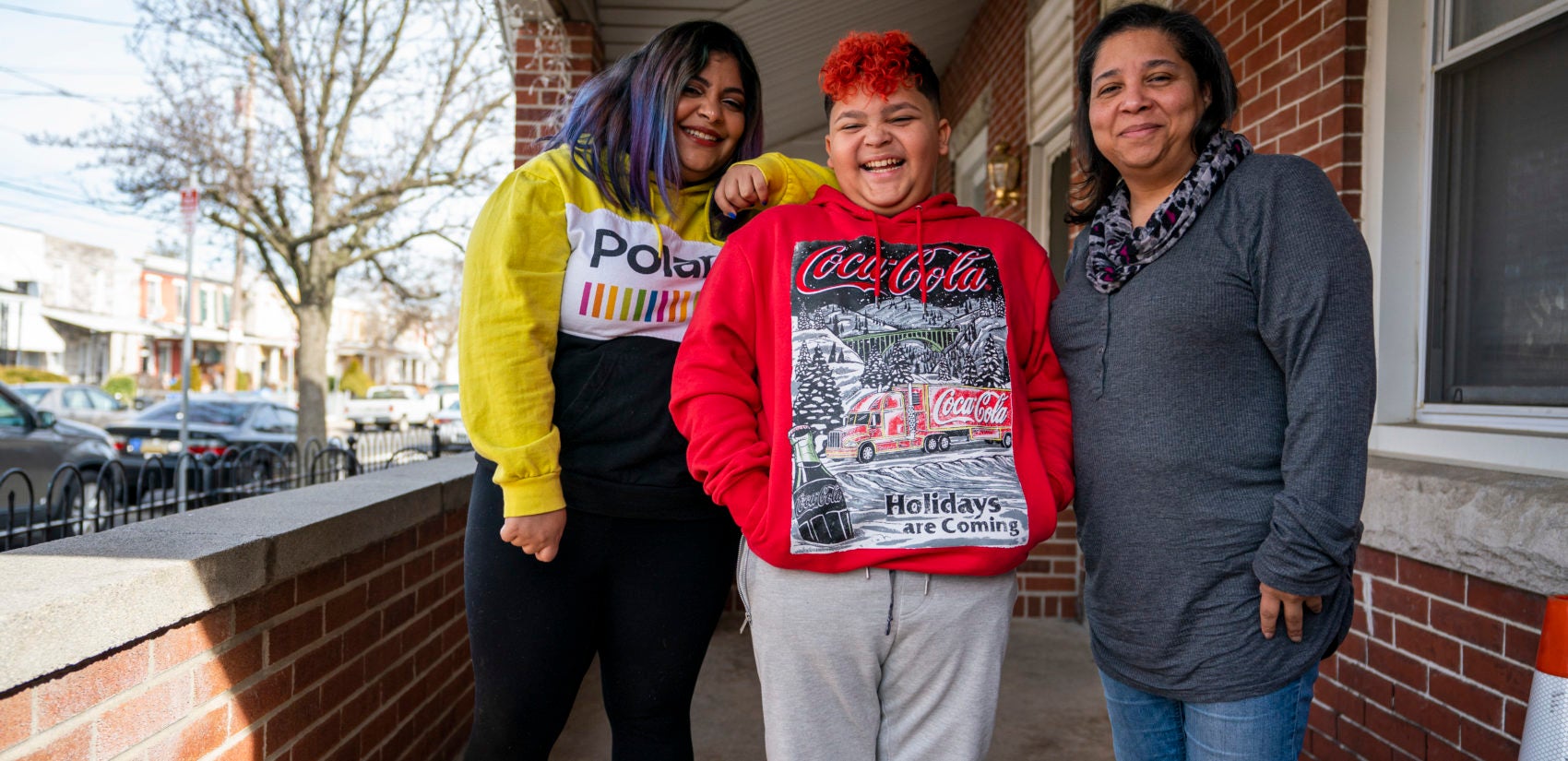 Yali Perez (left), her son Ian and her mother Brenda Santiago on their porch in Bridesburg. Although still wary, Yali says she has a 
