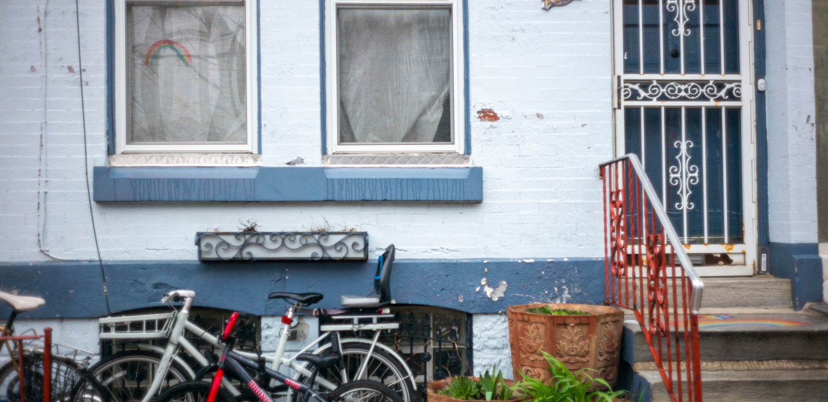 A rainbow drawn in a South Philadelphia window. (Jessica Kourkounis for Keystone Crossroads)