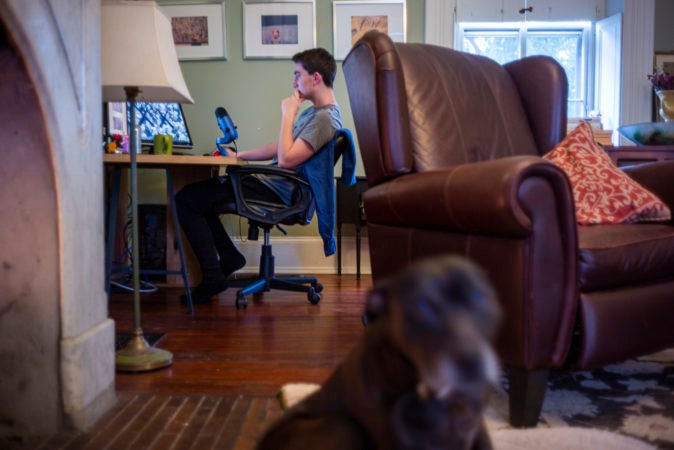 Riley Prell, a high-school freshman at Science Leadership Academy, is isolated at home with his two parents and his college-aged sister. (Jessica Kourkounis for Keystone Crossroads)