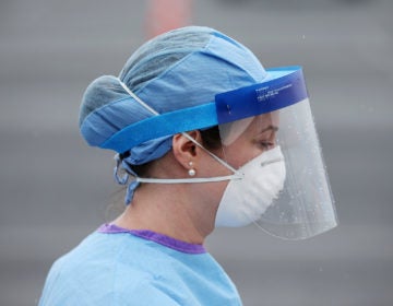 Jamie Huot, a Philadelphia Medical Reserve Corps volunteer and nurse, walks to the swabbing tent before the city's coronavirus testing site opened next to Citizens Bank Park in South Philadelphia on Friday, March 20, 2020. (The Philadelphia Inquirer)