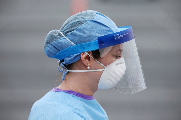 Jamie Huot, a Philadelphia Medical Reserve Corps volunteer and nurse, walks to the swabbing tent before the city's coronavirus testing site opened next to Citizens Bank Park in South Philadelphia on Friday, March 20, 2020. (The Philadelphia Inquirer)