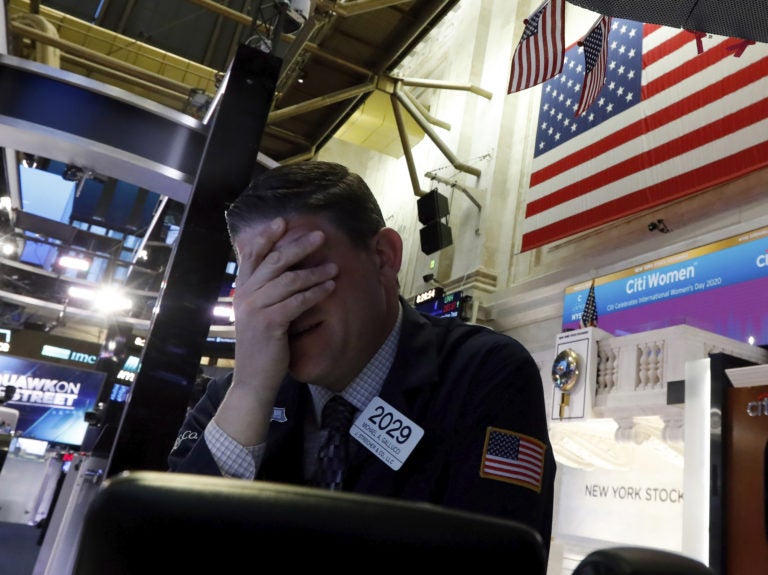 A trader reacts on the floor of the New York Stock Exchange on Monday. Major U.S. stock indexes plunged 7% before trading was temporarily halted. A trader reacts on the floor of the New York Stock Exchange on Monday. Major U.S. stock indexes plunged 7% before trading was temporarily halted. (Richard Drew/AP)