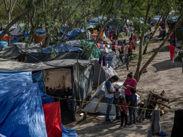 Clothing hangs to dry at a makeshift migrant camp for asylum seekers in Matamoros, Tamaulipas state, Mexico, on earlier this month. About 60,000 migrants live in filthy and dangerous conditions as they await their day in U.S. immigration court. (Alejandro Cegarra/Bloomberg via Getty Images)