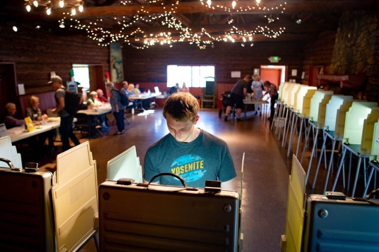 Voters fill out their ballots for the presidential primary in a log cabin run by the American Legion in San Anselmo, Calif., on Super Tuesday, March 3, 2020. While no significant foreign interference was detected, election and law enforcement officials are closely monitoring this year's primaries. (John Edelson/AFP via Getty Images)