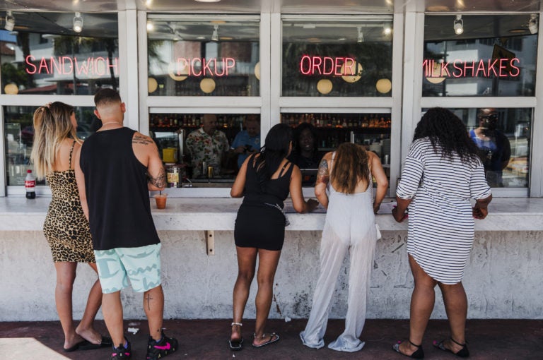 Customers at this take-out window in Miami on March 20 were not practicing social distancing. (Scott McIntyre/Bloomberg via Getty Images)