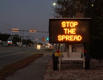 A sign warning motorists about the coronavirus in Key West, Fla. The U.S. Senate passed a $2 trillion relief measure Wednesday night intended to help hospitals, workers and businesses hit hard by the rapidly-spreading virus. (Joe Raedle/Getty Images)