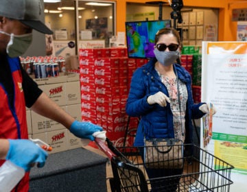 Even without symptoms, you might have the virus and be able to spread it when out in public, say researchers who now are reconsidering the use of surgical masks. (Elijah Nouvelage/Bloomberg via Getty Images)