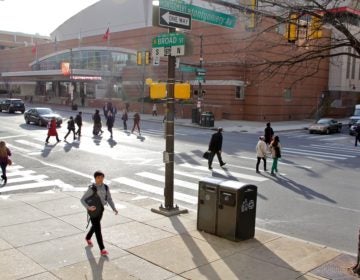 Students cross the street at Temple. Temple, Penn and other regional schools are closing campuses because of coronavirus concerns, making business unpredictable for restaurants near college campuses. (Emma Lee/WHYY)