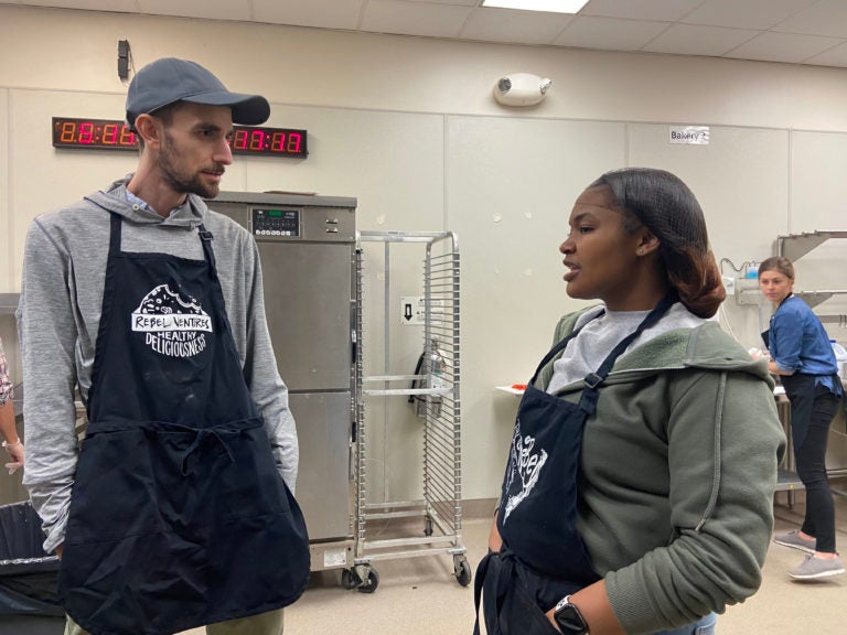 Rebel Ventures co-executive director Jarrett Stein talks with Kennysha Stanley. He and other mentors nominated her for the Breakfast Hero Award. (The Notebook)