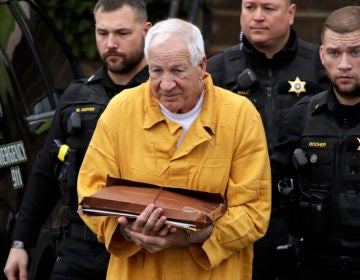 FILE - In this Nov. 22, 2019, file photo, former Penn State University assistant football coach Jerry Sandusky, center, arrives at the Centre County Courthouse to be resentenced in Bellefonte, Pa. Jerry Sandusky's legal effort to have his decadeslong child molestation sentence reduced will be the subject of a hearing Tuesday, Jan. 28, 2020, in a Pennsylvania courtroom. (AP Photo/Gene J. Puskar, File)