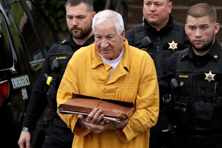 FILE - In this Nov. 22, 2019, file photo, former Penn State University assistant football coach Jerry Sandusky, center, arrives at the Centre County Courthouse to be resentenced in Bellefonte, Pa. Jerry Sandusky's legal effort to have his decadeslong child molestation sentence reduced will be the subject of a hearing Tuesday, Jan. 28, 2020, in a Pennsylvania courtroom. (AP Photo/Gene J. Puskar, File)