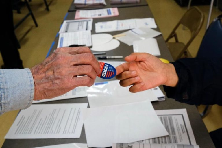 A voter receives his I-Voted sticker, at an early voting polling station at the Ranchito Avenue Elementary School in the Panorama City section of Los Angeles on Monday, March 2. (Richard Vogel/AP Photo)