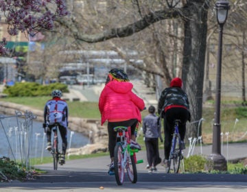 Bicyclists, joggers and walkers enjoy a beautiful day on the Schuylkill River Trail near Boathouse Row, on Thursday, April 2, 2020.
 (Emma Lee/WHYY)