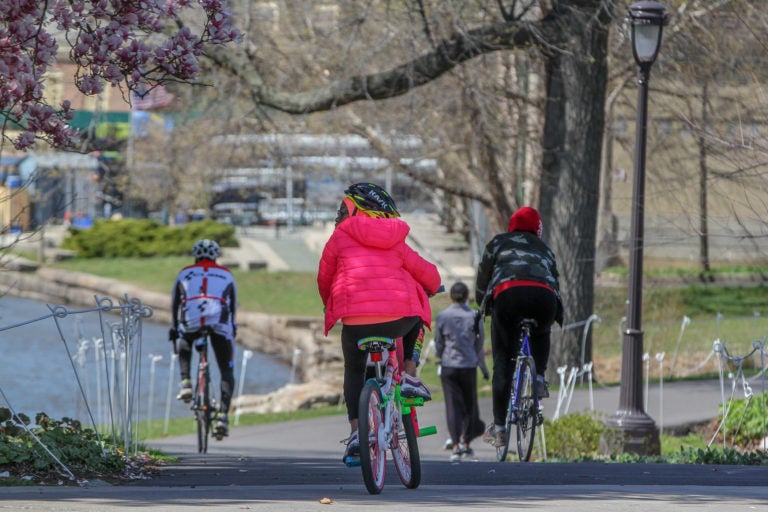 Bicyclists, joggers and walkers enjoy a beautiful day on the Schuylkill River Trail near Boathouse Row, on Thursday, April 2, 2020.
 (Emma Lee/WHYY)