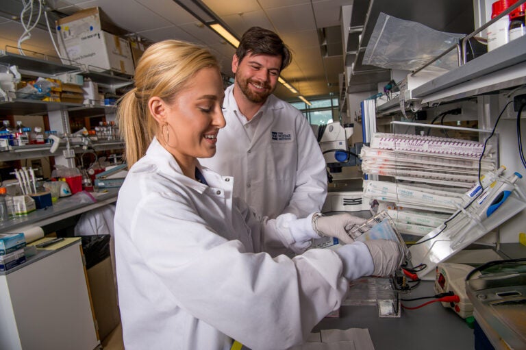 Dr. Dan Kulp, associate professor in Wistar’s Vaccine & Immunotherapy Center, works with a member of his lab.