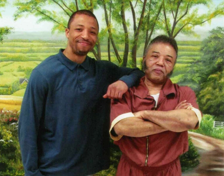 Rudolph Sutton poses with his son Rudolpho in a photo taken in 2015 at SCI-Graterford in Montgomery County, where Sutton was serving a life sentence. (Courtesy of Rudolpho Sutton)