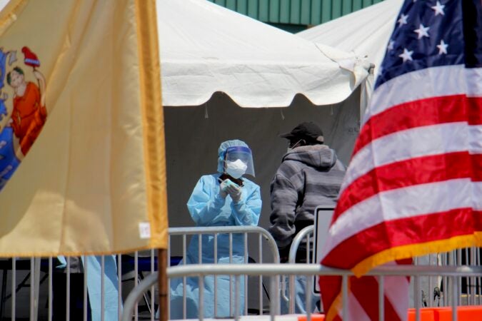 A candidate for COVID-19 testing is interviewed at a walk-up testing site at 2600 Mt. Ephraim Ave. in Camden, New Jersey. (Emma Lee/WHYY)