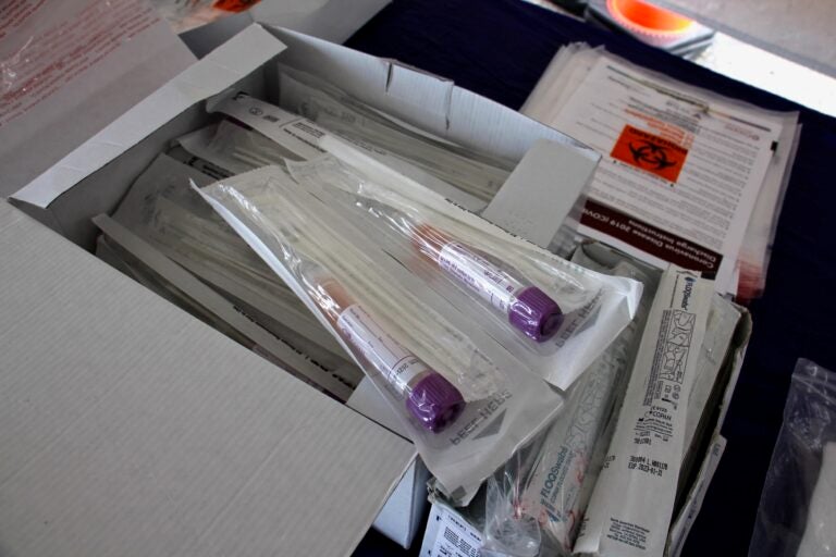 In this 2020 photo, COVID-19 test kits are laid out on a table at the testing site at 2600 Mt. Ephraim Ave., Camden, New Jersey. (Emma Lee/WHYY)