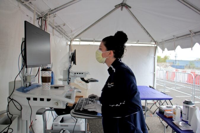 Medical technician Monica Campagna works at a COVID-19 testing site in the Motor Vehicle Commission parking lot in Camden New Jersey. (Emma Lee/WHYY)