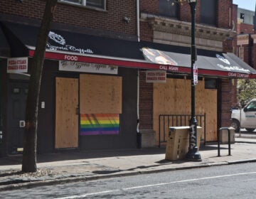 A pizza shop on 12th Street in Center City Philadelphia are boarded up during non-essential business shutdown orders aimed to slow the spread of COVID-19. (Kimberly Paynter/WHYY)