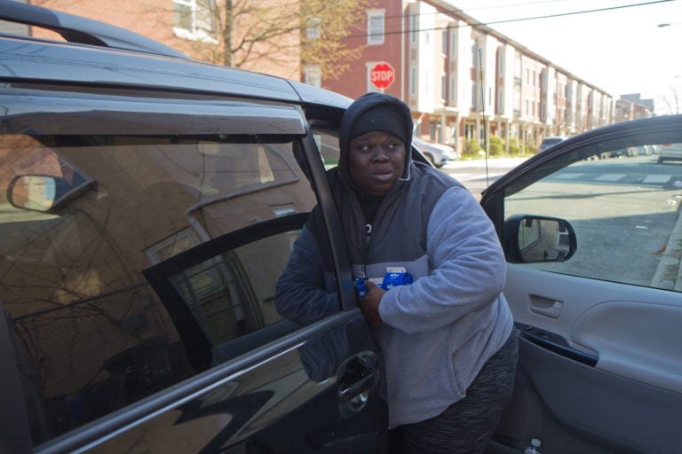 Sam Samuel delivers school lunches out of her van to families in West Philly's Mantua neighborhood. (Kimberly Paynter/WHYY)