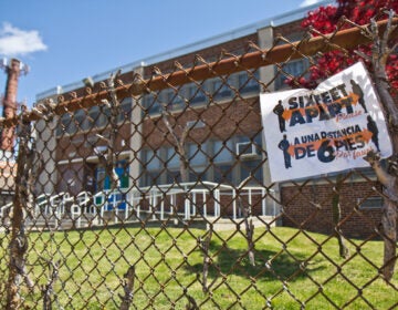 A social distancing notice on the fence of William H. Ziegler Elementary school in Northeast Philadelphia. (Kimberly Paynter/WHYY)