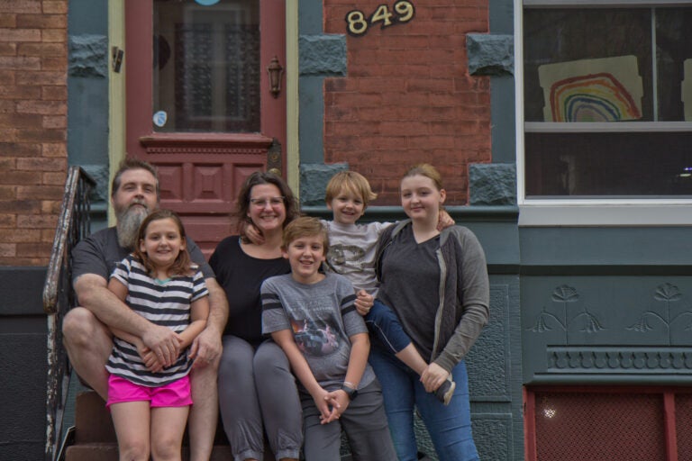 Wayne and Andrea Clark with their children Molly, 9, Caleb, 11, Roisin, 13, and Cianan, 6, on the steps of their home in Philadelphia. (Kimberly Paynter/WHYY)