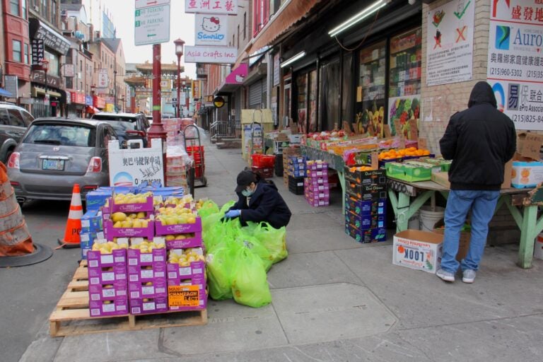 A produce market at 10th and Cherry streets is one of the few businesses still open in Chinatown. (Emma Lee/WHYY)