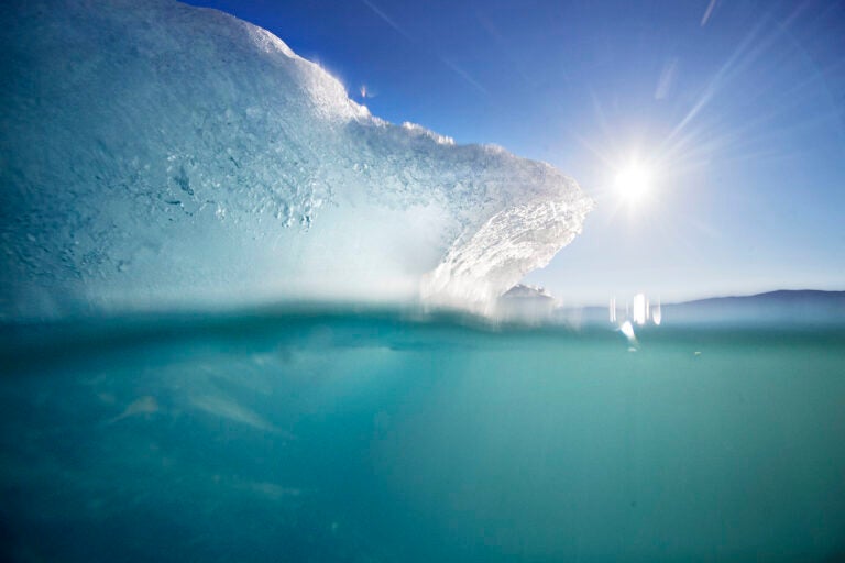 An icebergs floats in the Nuup Kangerlua Fjord in southwestern Greenland. Greenland's glaciers have been melting and retreating at an accelerated pace in recent years due to warmer temperatures. (AP Photo/David Goldman)