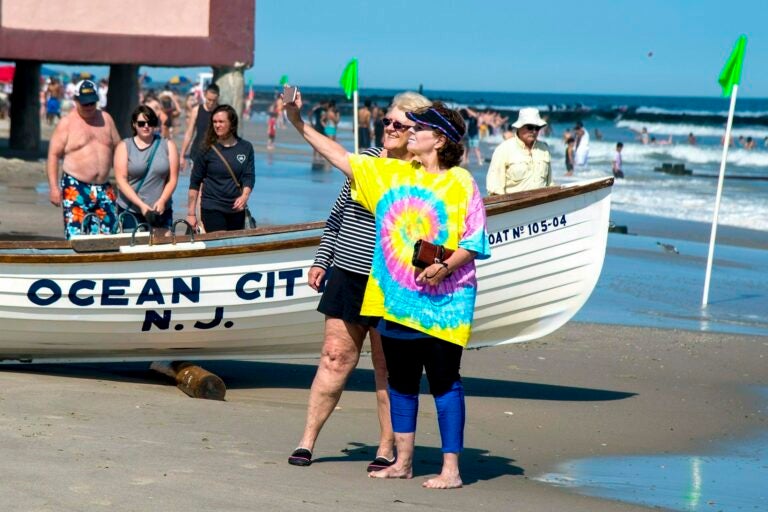 Jeanne Landgraf (left) of Mayfair, in Philadelphia, and Liz Thomsen (right) from Bailey, Colorado, shoot a selfie on the beach in Ocean City on May 27, 2019. (Tom Gralish/The Philadelphia Inquirer via AP)