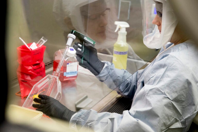 Laboratory Scientist Andrea Luquette cultures coronavirus to prepare for testing at U.S. Army Medical Research and Development Command at Fort Detrick in Frederick, Md., Thursday, March 19, 2020. (AP Photo/Andrew Harnik)