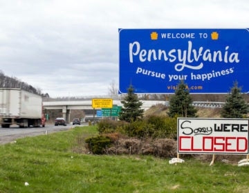 A sign reading “Sorry We’re Closed” is placed at the Pennsylvania welcome sign on the westbound lanes of Interstate 80 in Delaware Water Gap, Pa. on Saturday, April 4, 2020. (Christopher Dolan/The Times-Tribune via AP)
