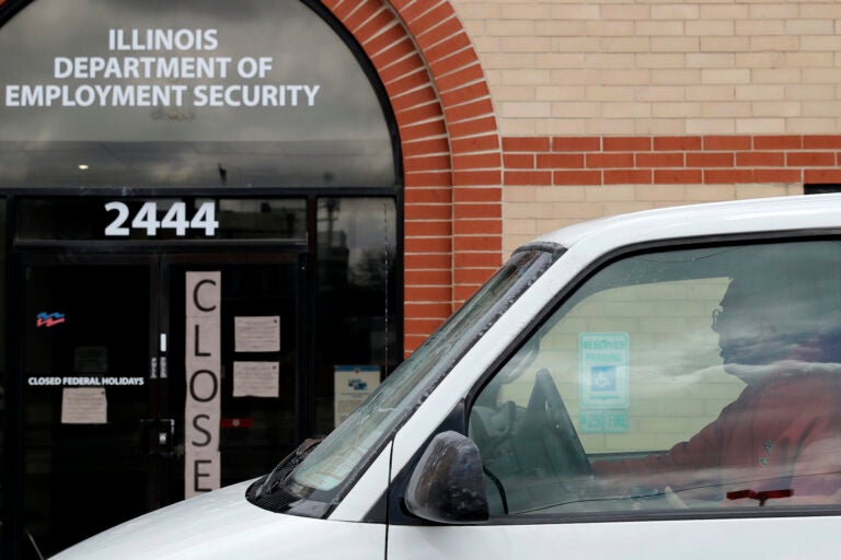 A man looks at the closed sign in front of Illinois Department of Employment Security in Chicago, Wednesday, April 15, 2020. More than 500,000 Illinois residents filed unemployment claims in just a five-week span during COVID-19 pandemic.  (AP Photo/Nam Y. Huh)